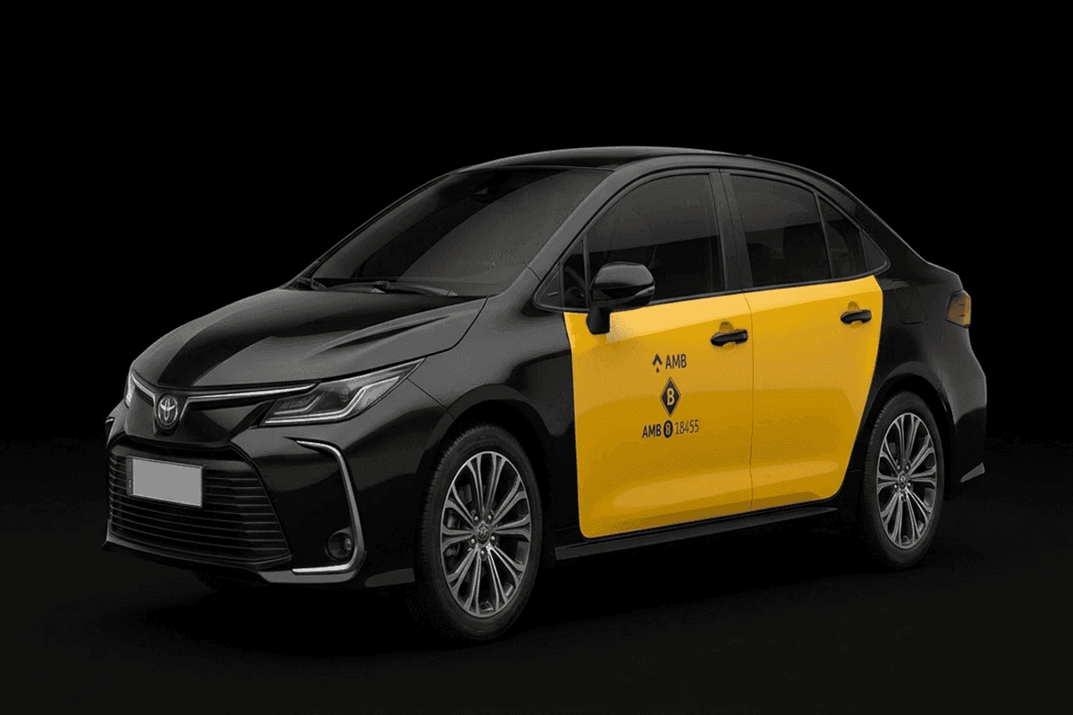 Toyota Corolla sedan Barcelona airport taxi in official black and yellow AMB livery, seats 4 passengers with 3 suitcases